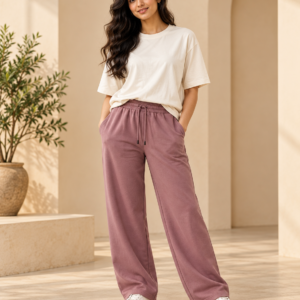 Woman wearing an ivory relaxed-fit T-shirt with dusty mauve joggers